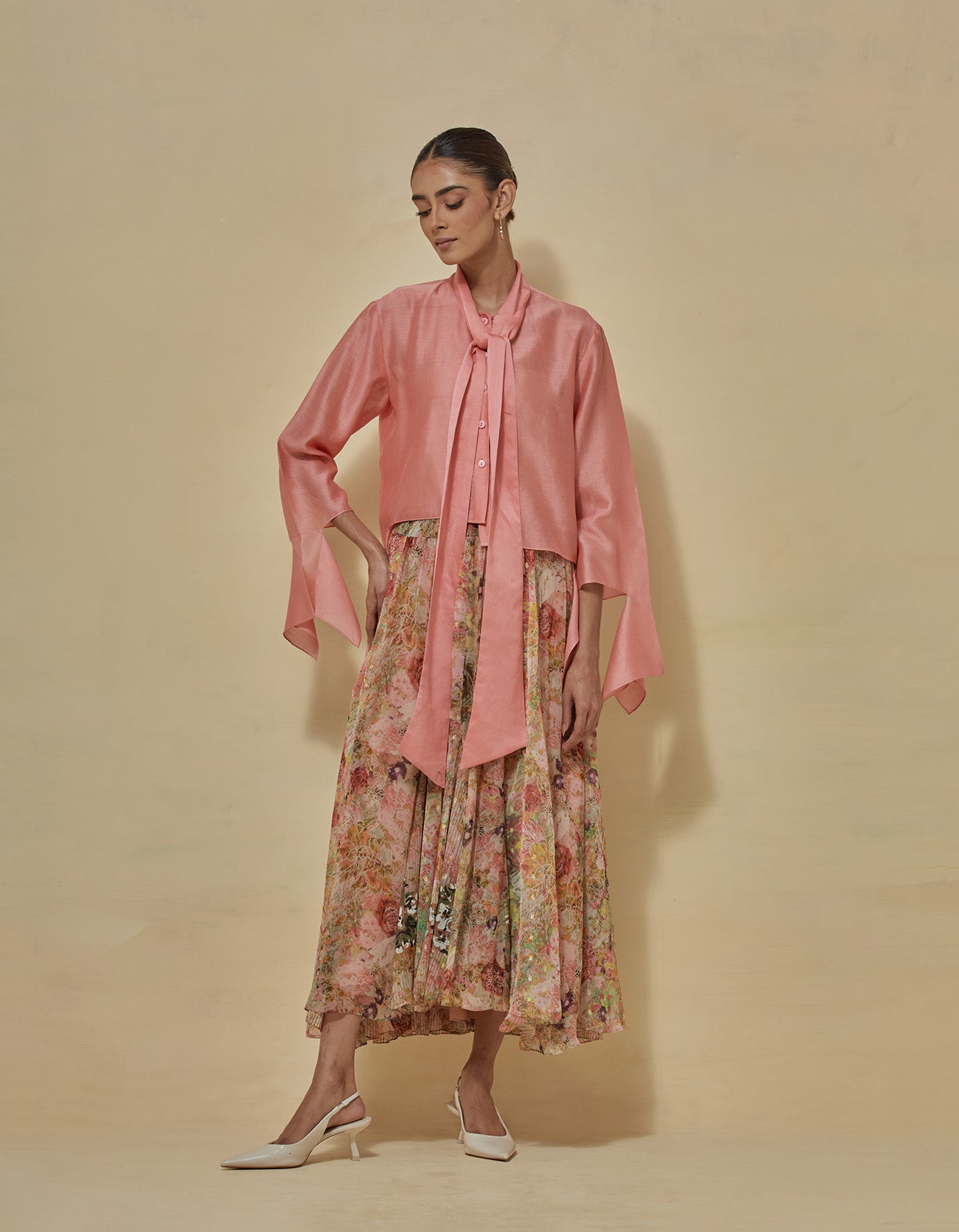 Peachish coral chanderi tie collar shirt paired with lurex chiffon printed godet skirt