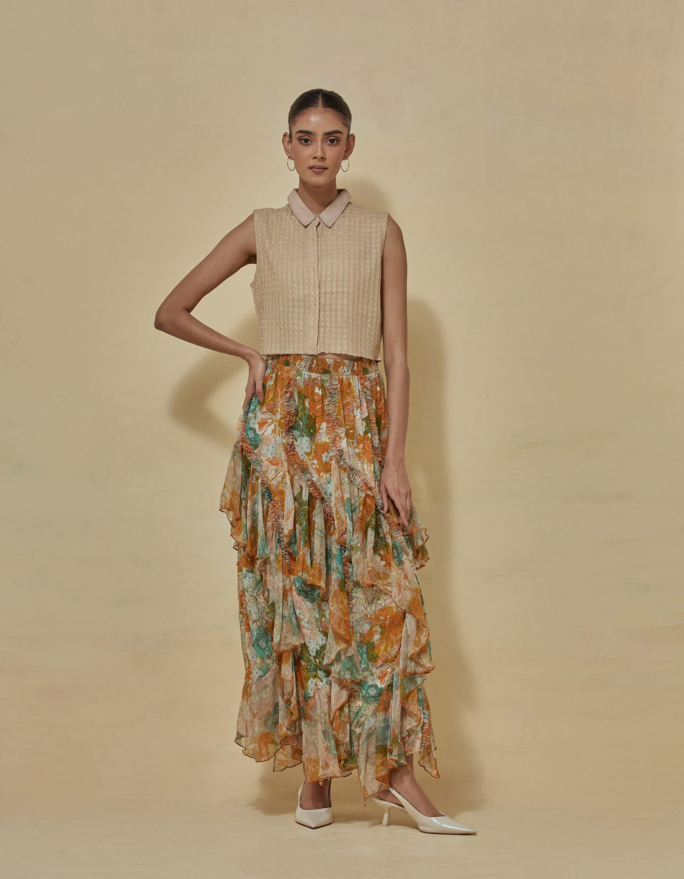 Beige thread textured g sleeveless crop shirt paired with printed skirt
