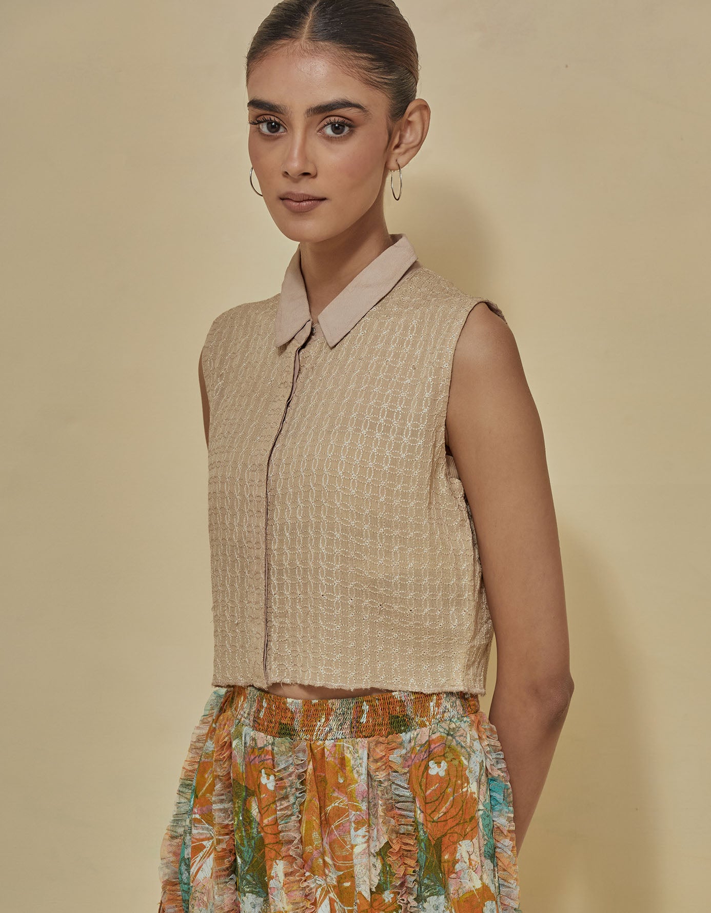 Beige thread textured g sleeveless crop shirt paired with printed skirt