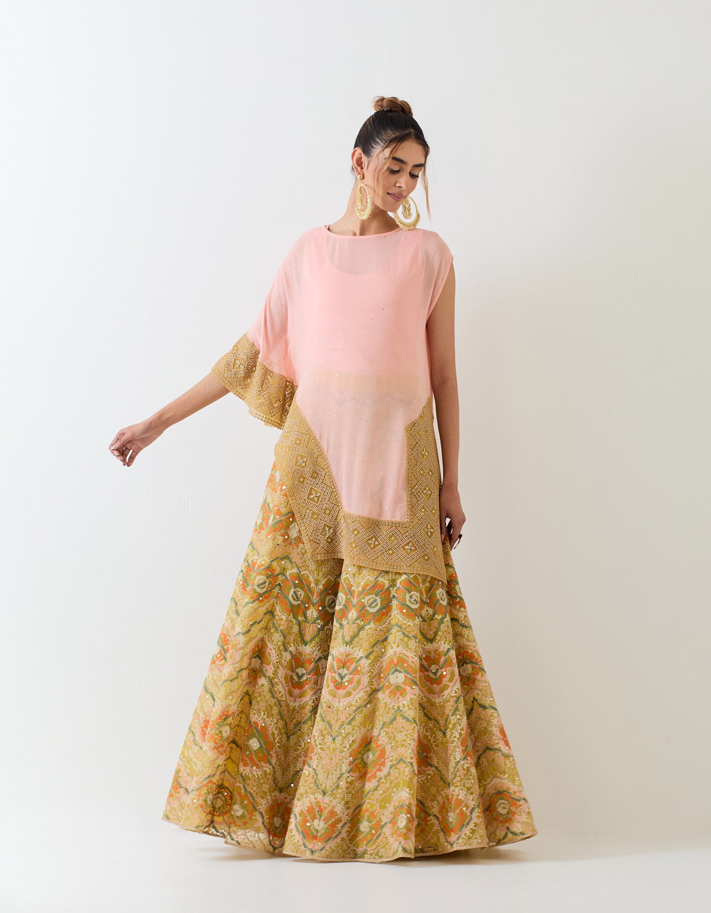 Pale pink muqaish georgette asymetric cape paired with organza cross stitch embroidered sharara pants