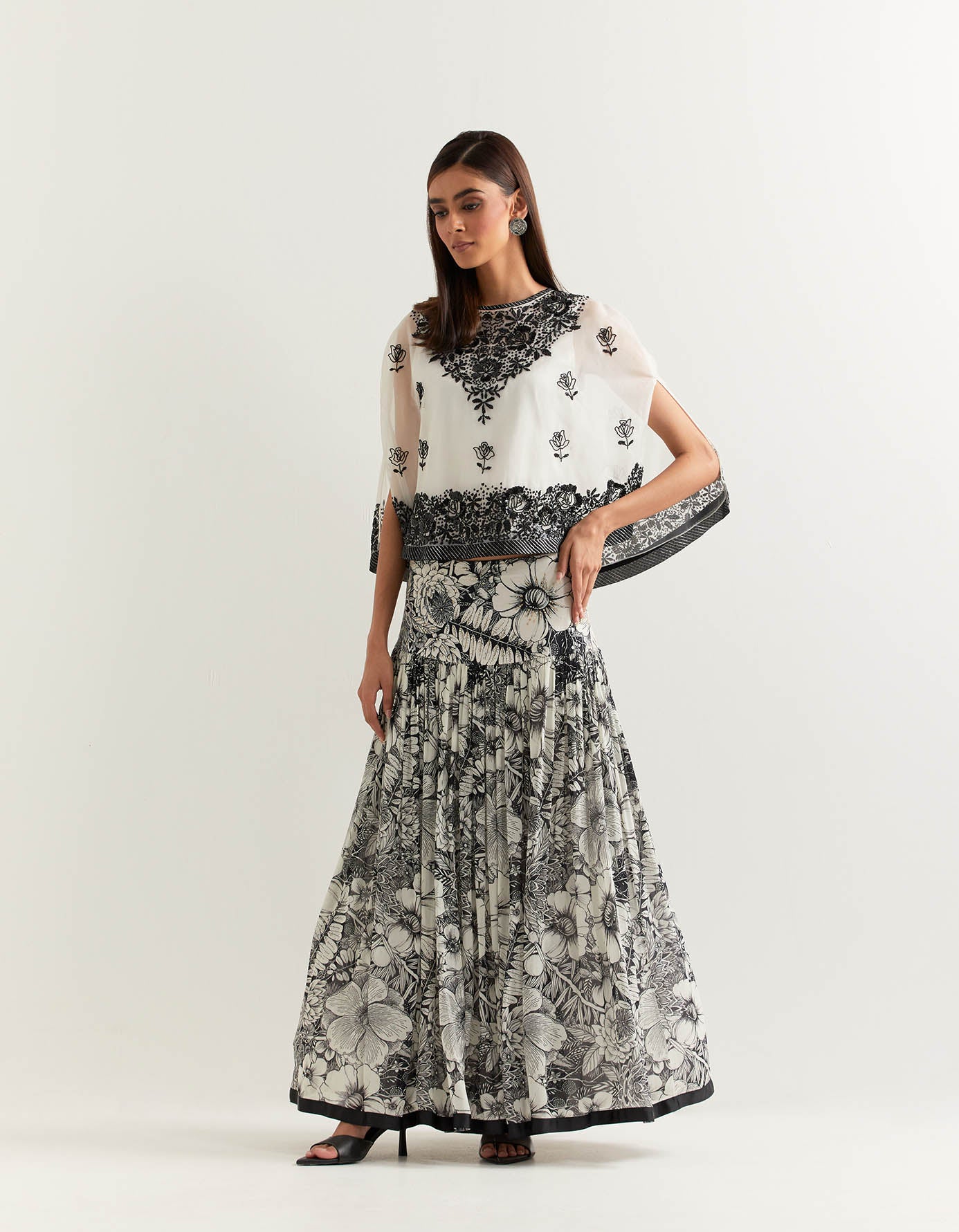 Organza cape embellished with hand sequins embroidery paired with printed gathered georgette skirt