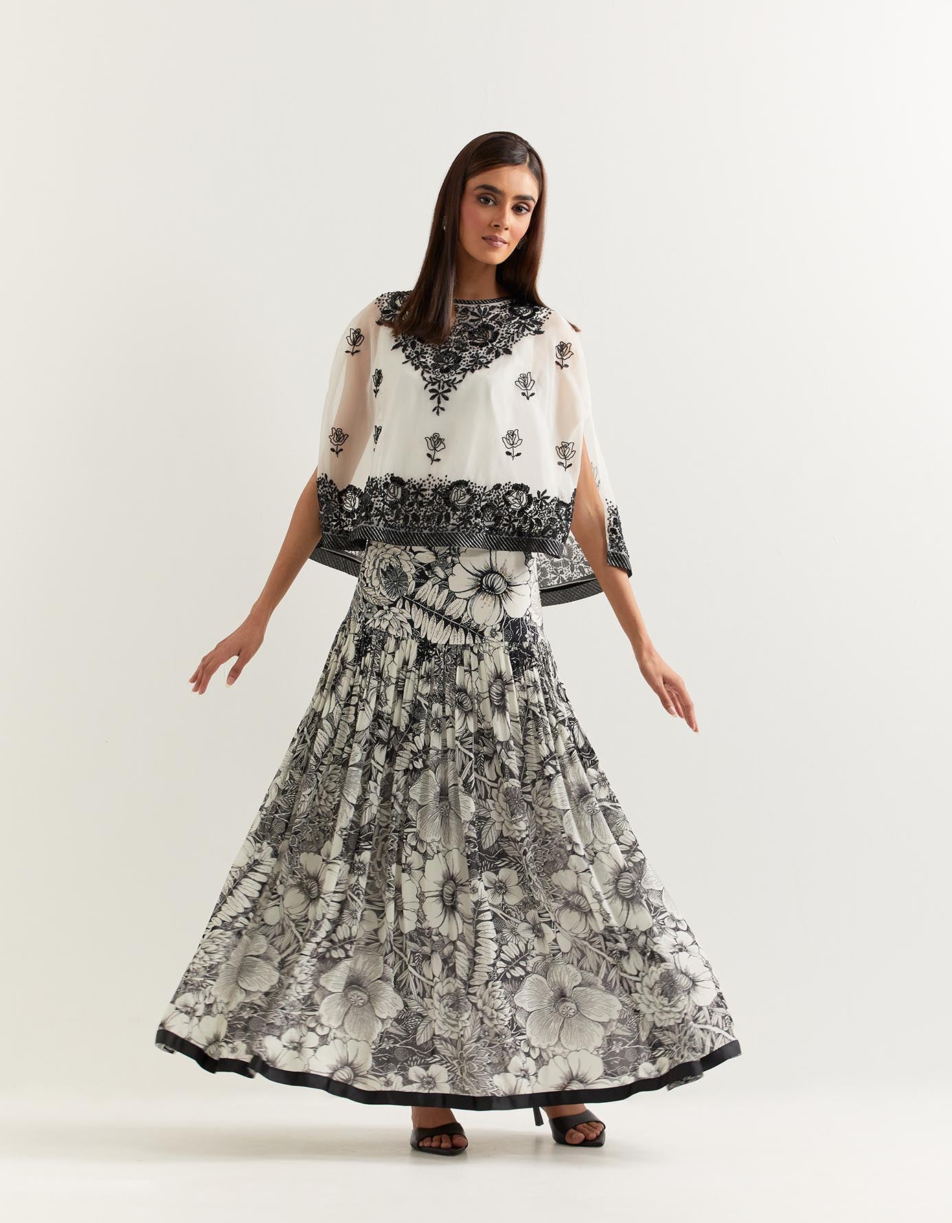 Organza cape embellished with hand sequins embroidery paired with printed gathered georgette skirt