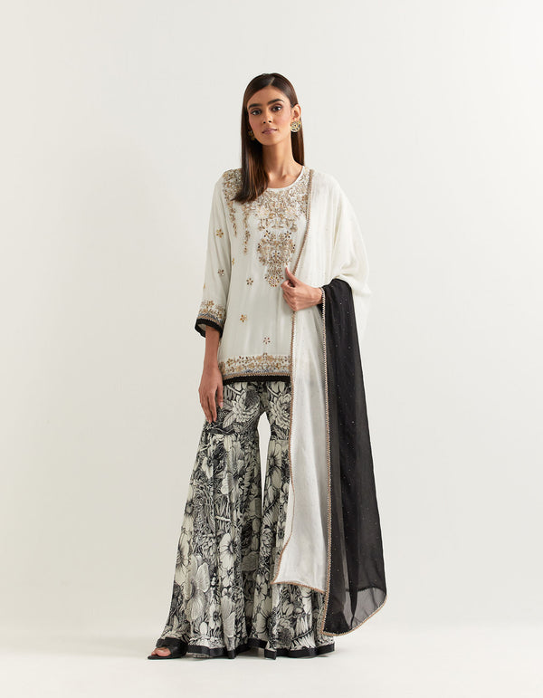 Black and ivory sharara set in exquisite hand embroidery and muqaish work dupatta