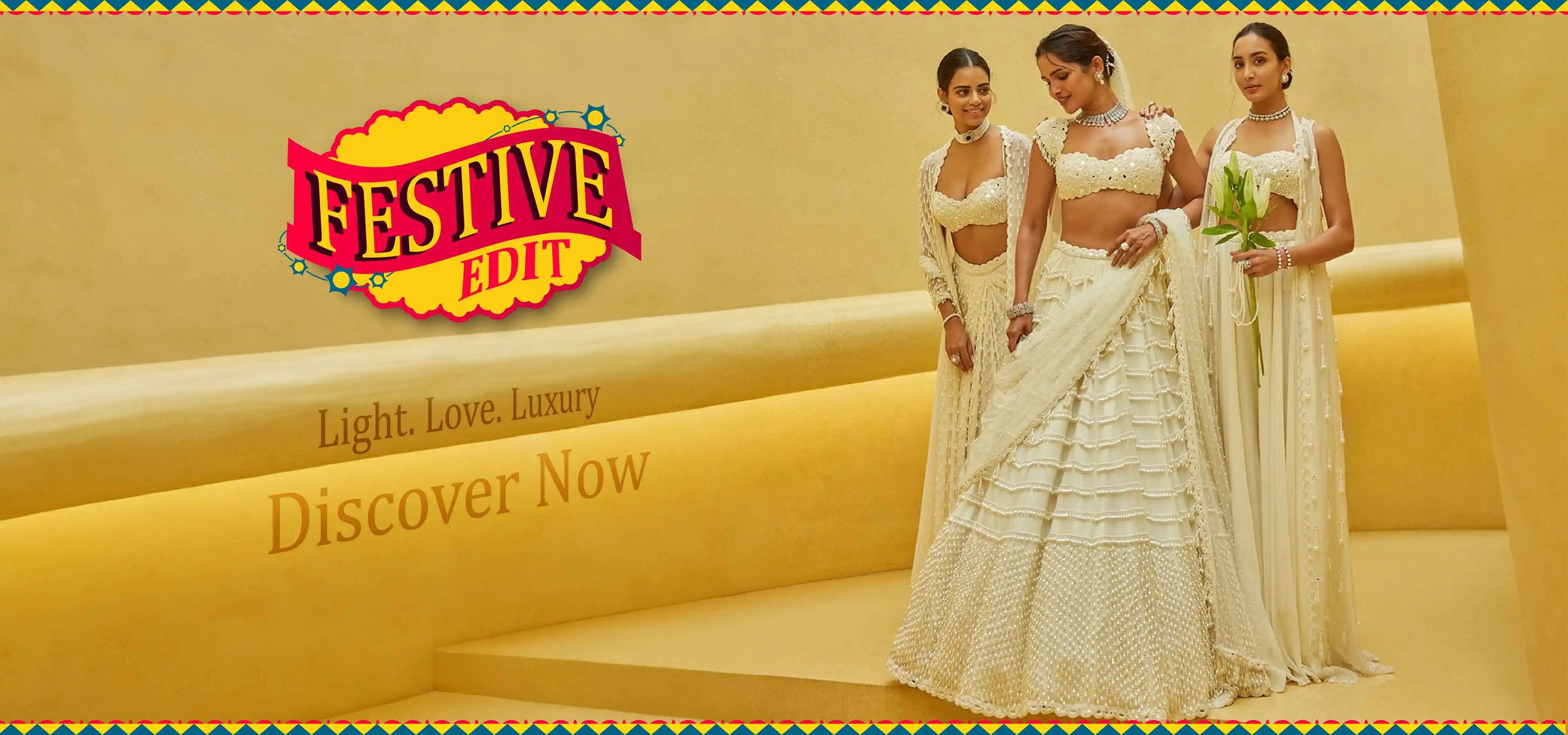 Three women in traditional white outfits standing against a yellow background with 'Festive Edit' branding.
