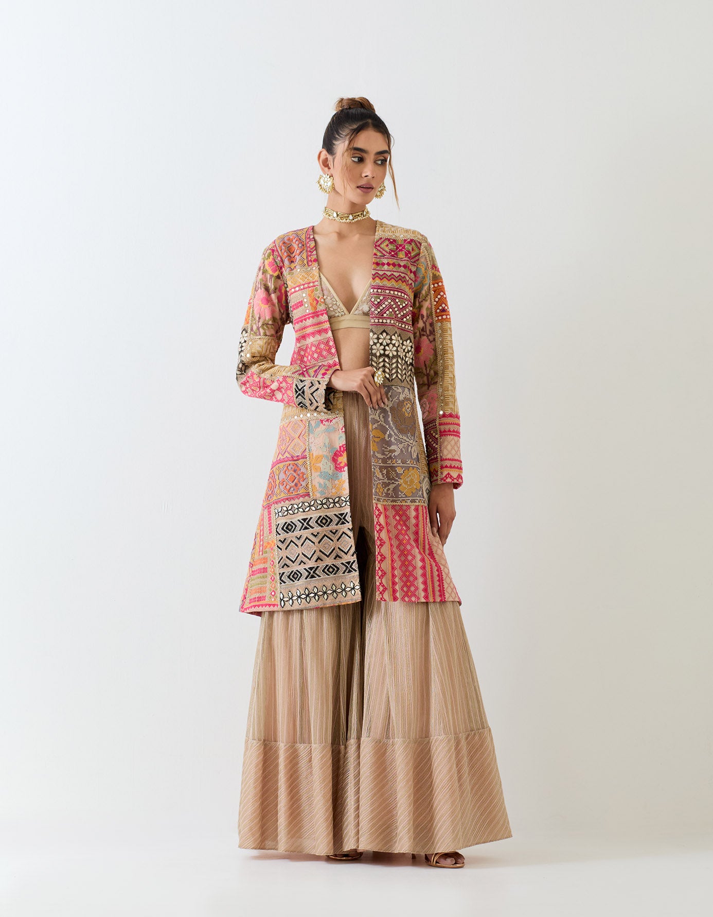 Patch work embroidered long jacket paired with textured sharara pants and patch work embroidered bralet