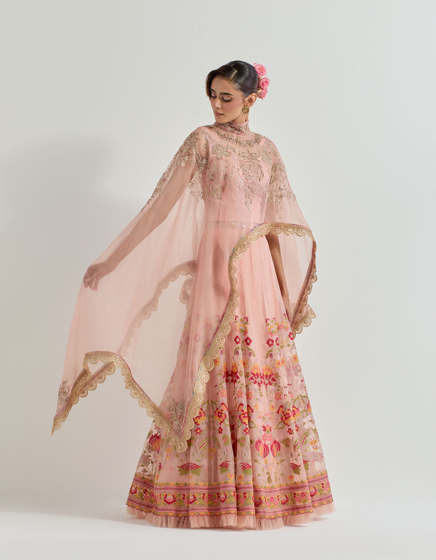 Hand emebllished dupatta cape paired with cross stitch embroidered skirt with frill detail at the hem