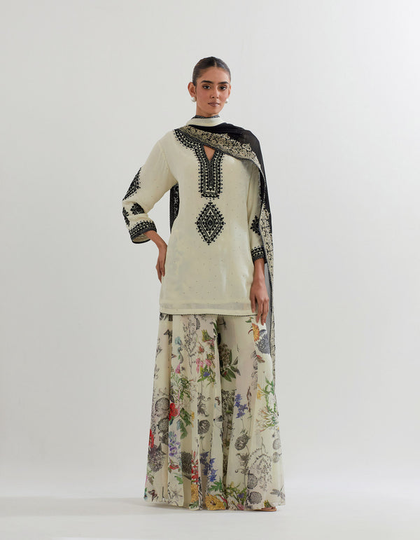 Botanical printed sharara paired with embroidered kurti and dupatta