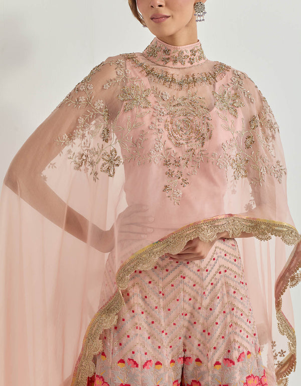 Hand emebllished high low cape paired with cross stitch embroidered sharara in peony motifs