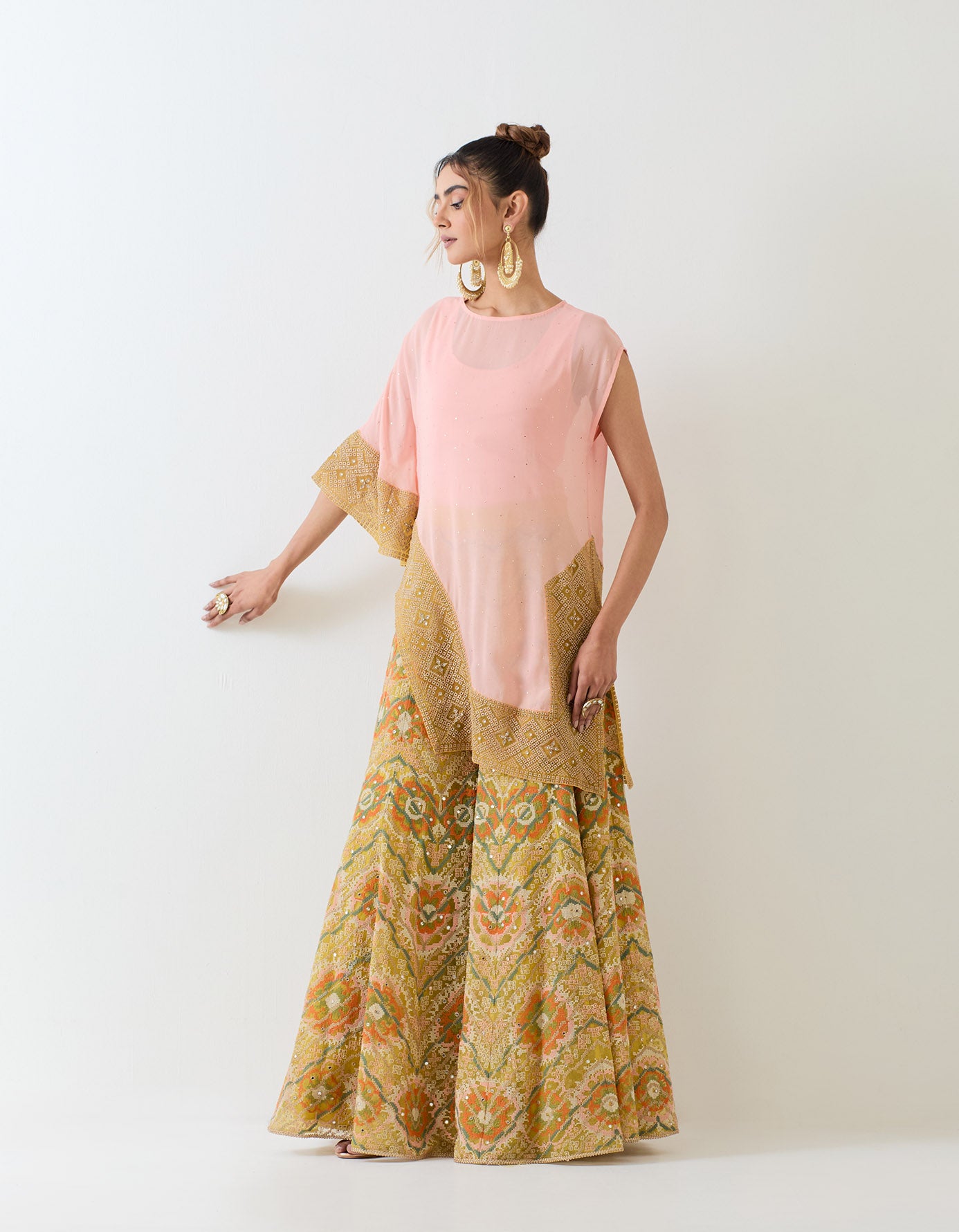 Pale pink muqaish georgette asymetric cape paired with organza cross stitch embroidered sharara pants