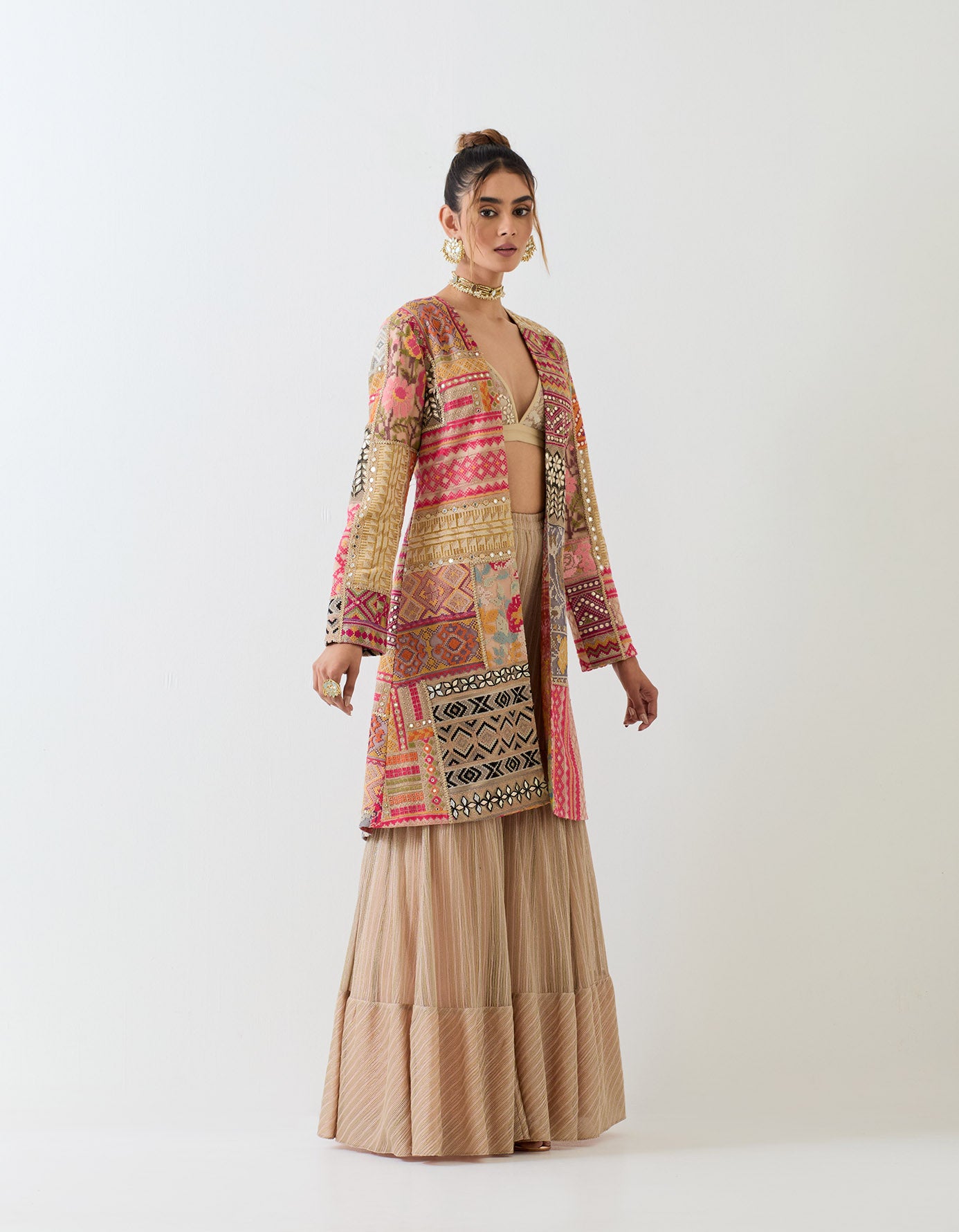 Patch work embroidered long jacket paired with textured sharara pants and patch work embroidered bralet