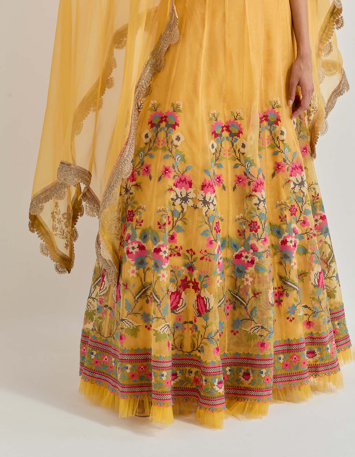 Hand emebllished dupatta cape paired with cross stitch embroidered skirt with frill detail at the hem