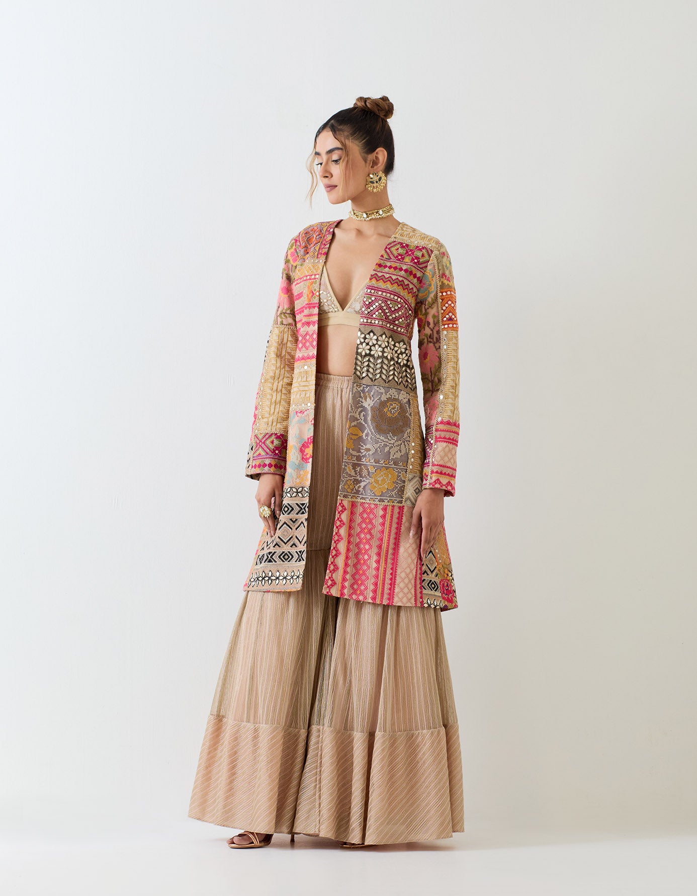 Patch work embroidered long jacket paired with textured sharara pants and patch work embroidered bralet