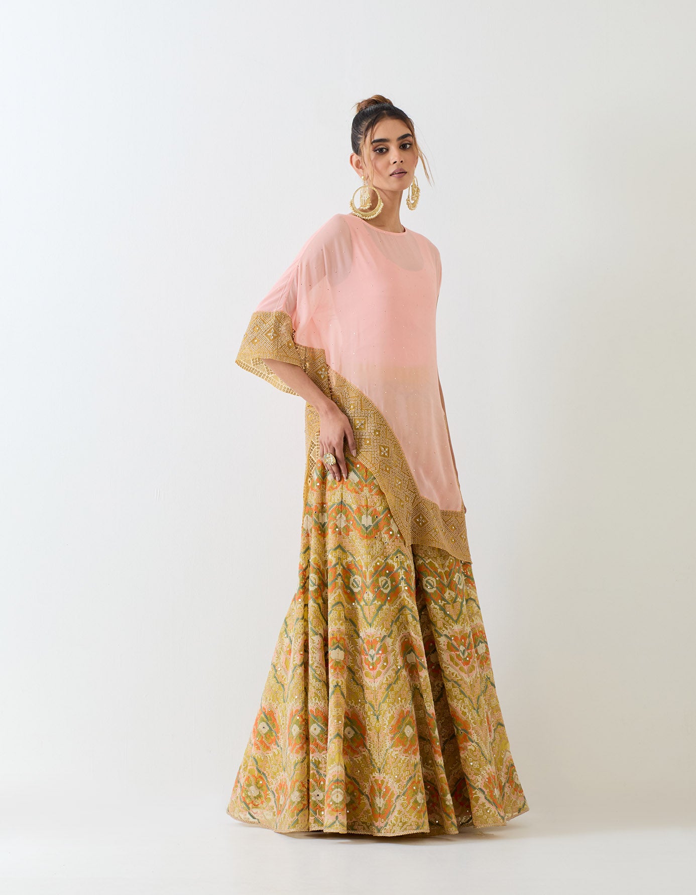 Pale pink muqaish georgette asymetric cape paired with organza cross stitch embroidered sharara pants