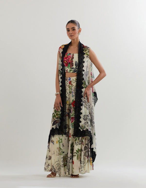 Botanical printed panelled pants paired with stretch bustier and cape