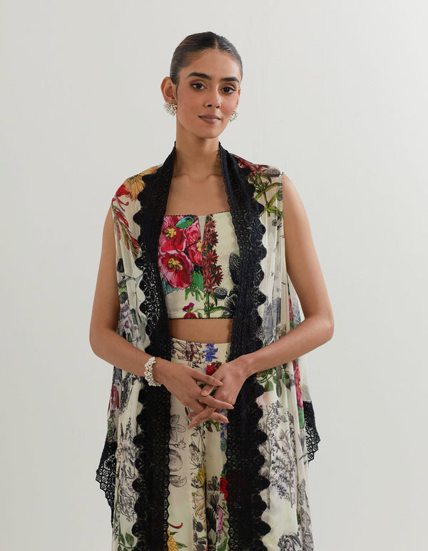 Botanical printed panelled pants paired with stretch bustier and cape