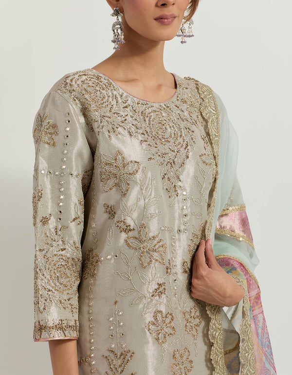 Sage tissue hand embellished long tunic paired with tissue bandhini printed pleated sharara and organza and tissue patch work dupatta