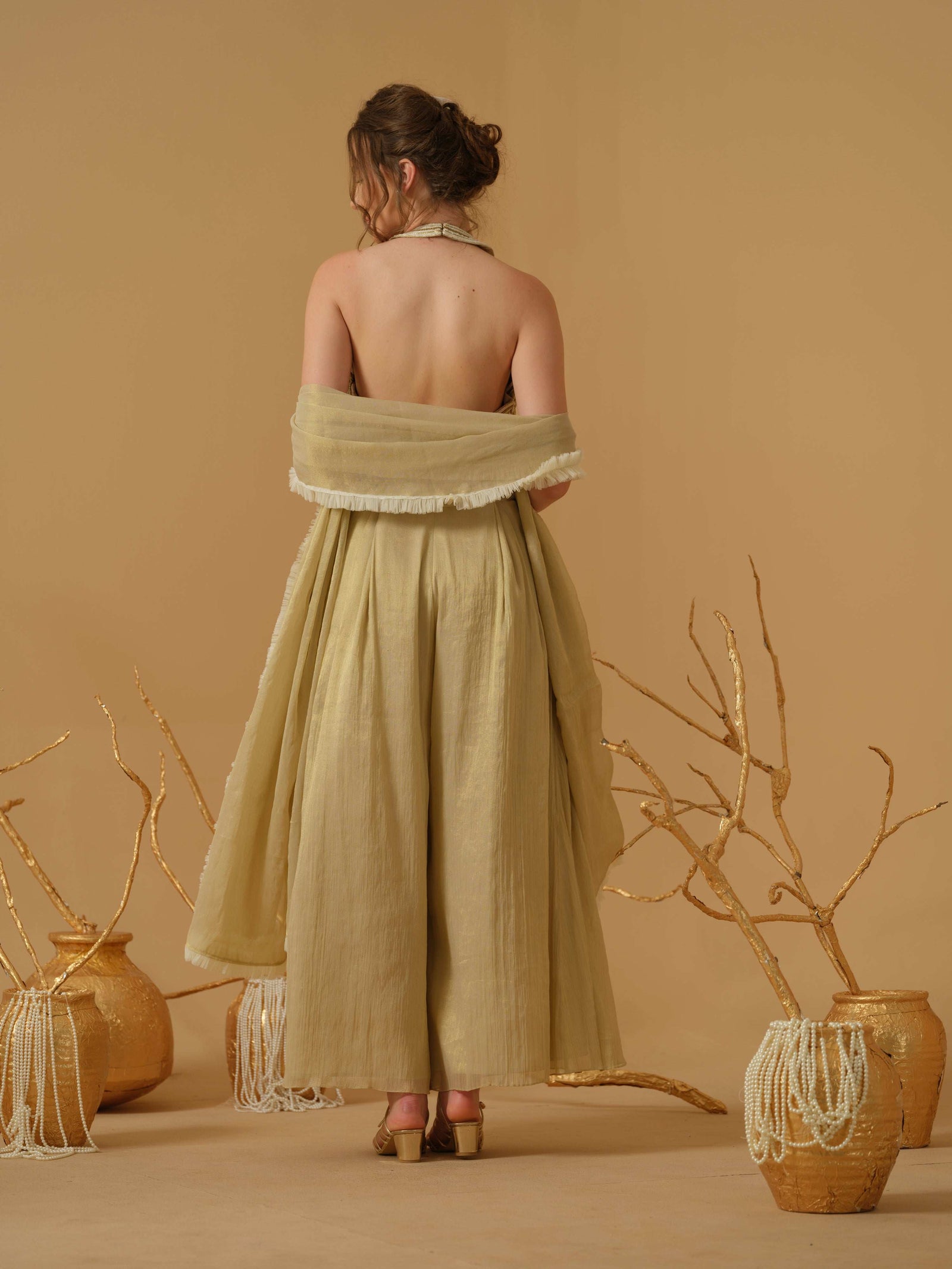 A Halter Neck Blouse Having  Floral Embroidery  Paired With Culotte Pant