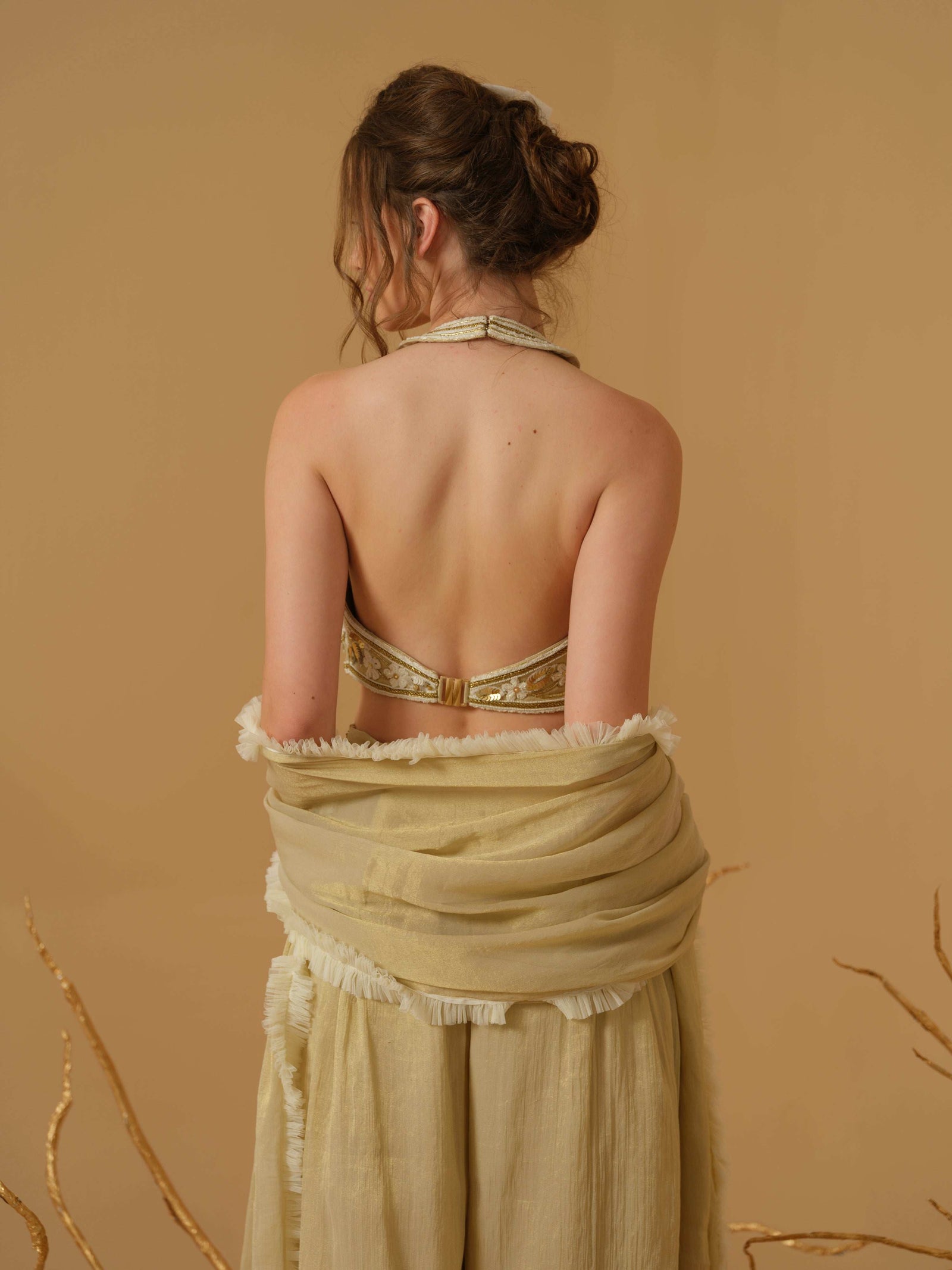 A Halter Neck Blouse Having  Floral Embroidery  Paired With Culotte Pant