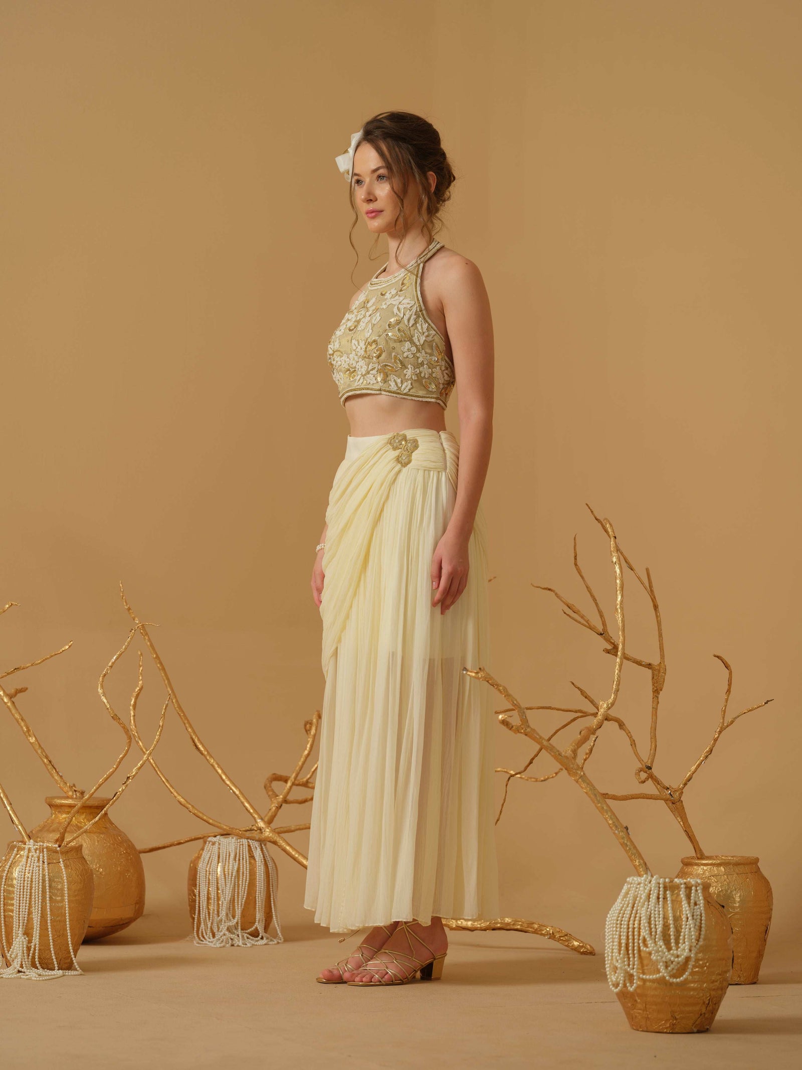 A  Halter Neck Blouse Having  Floral Embroidery  Paired With Draped Skirt