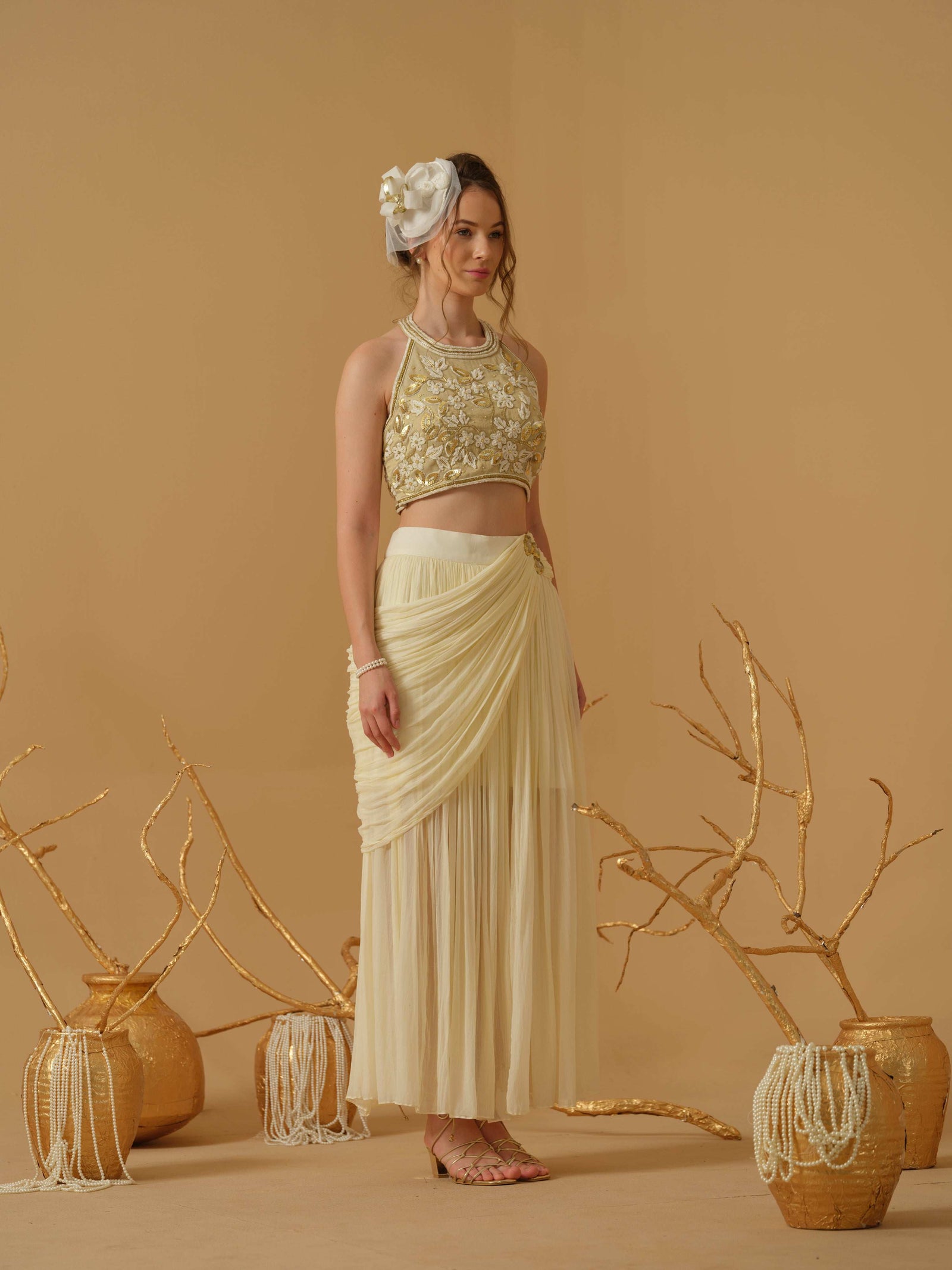 A  Halter Neck Blouse Having  Floral Embroidery  Paired With Draped Skirt