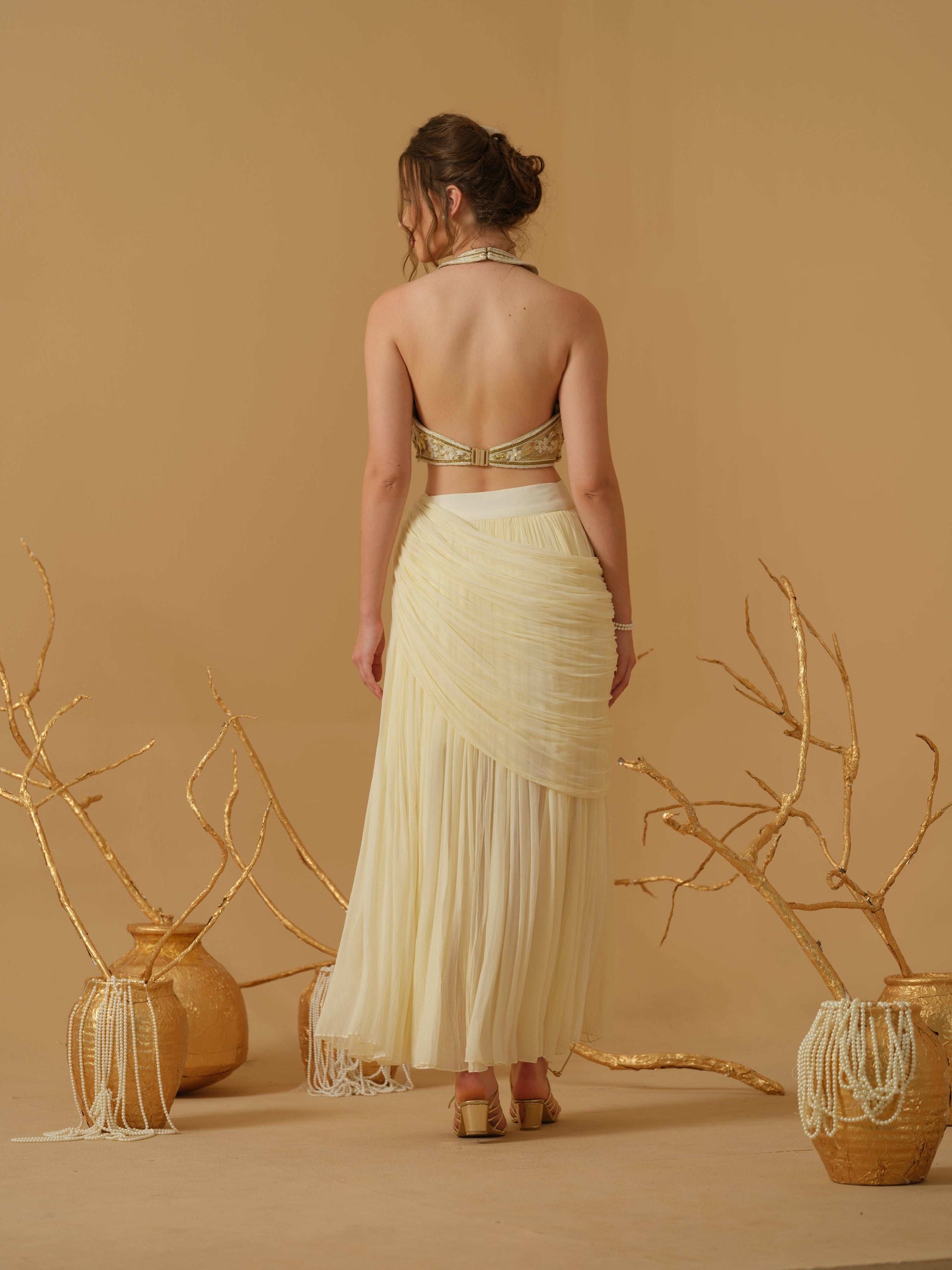 A  Halter Neck Blouse Having  Floral Embroidery  Paired With Draped Skirt