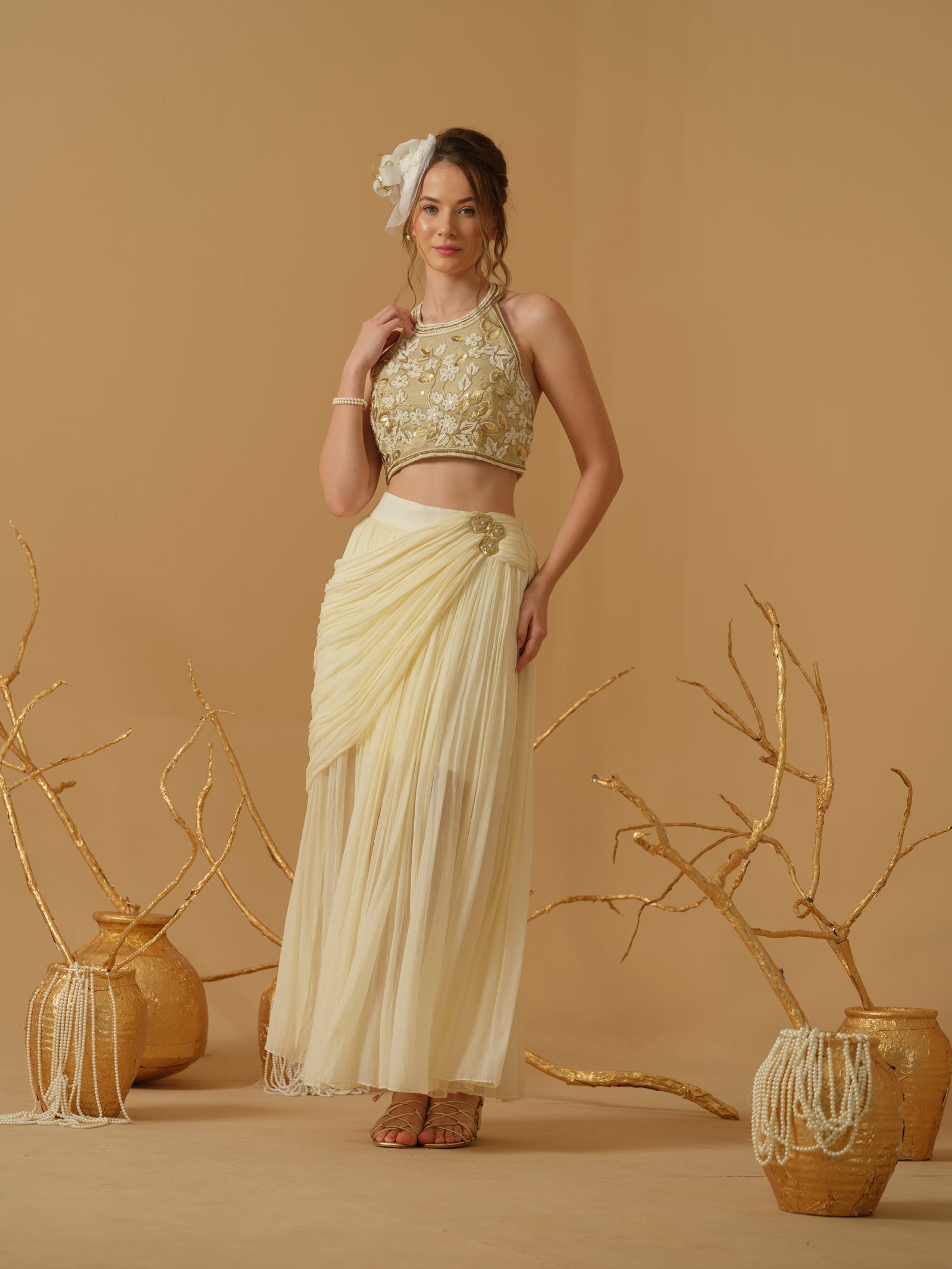 A  Halter Neck Blouse Having  Floral Embroidery  Paired With Draped Skirt