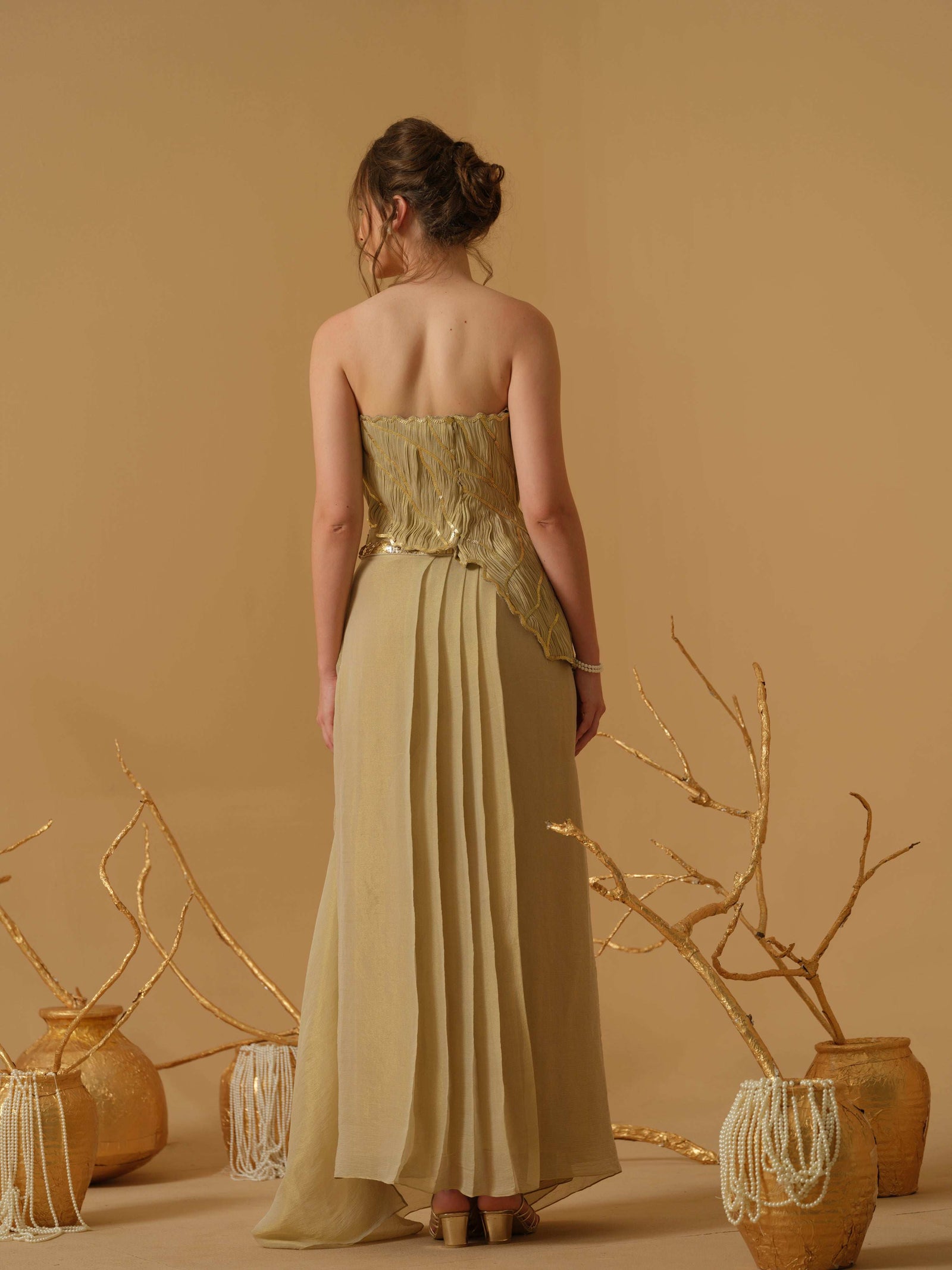 Featuring An Asymmetrical Ruched Tube Top