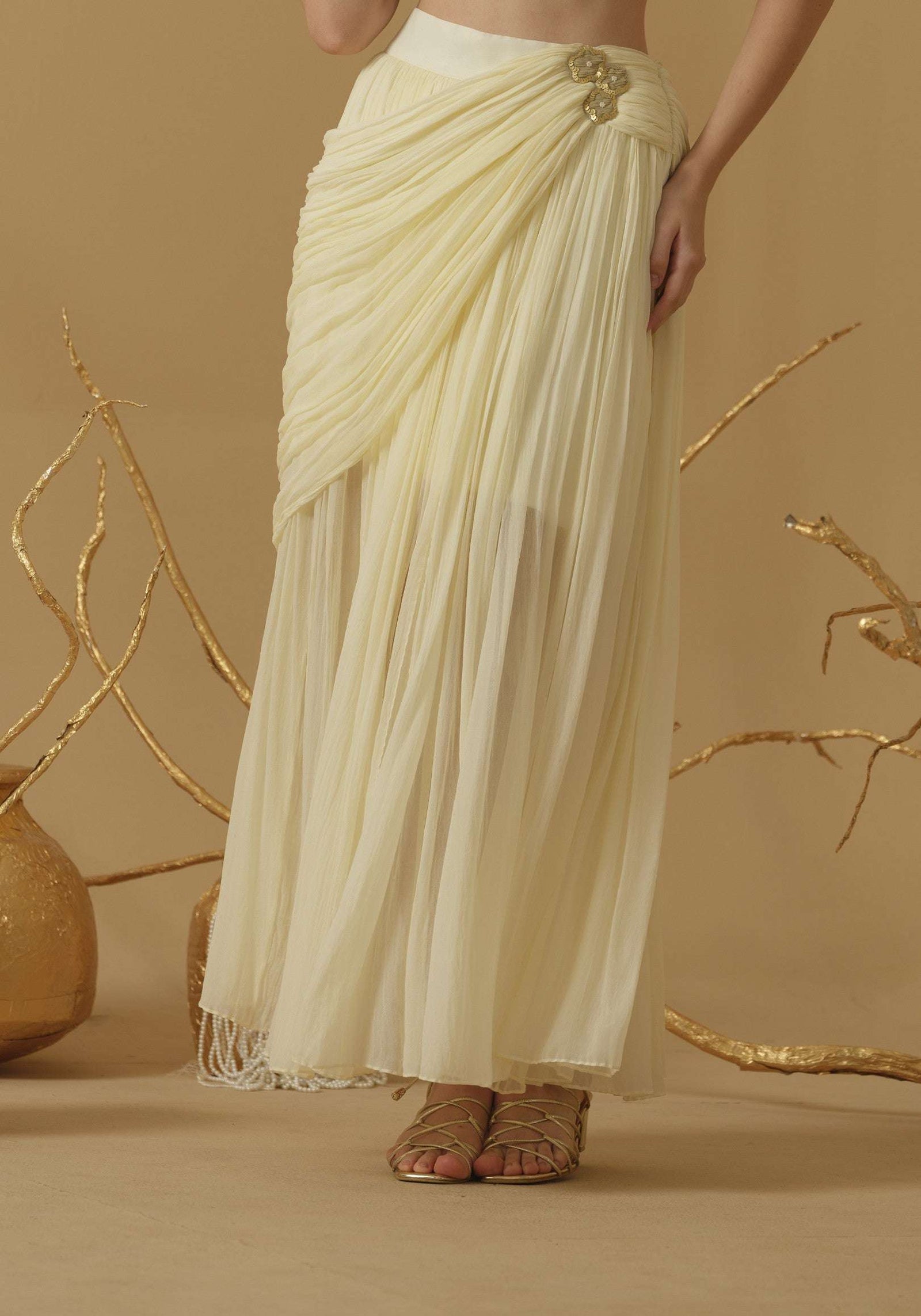Draped Skirt With Slit Having A Brooch On The Side Of The Waist