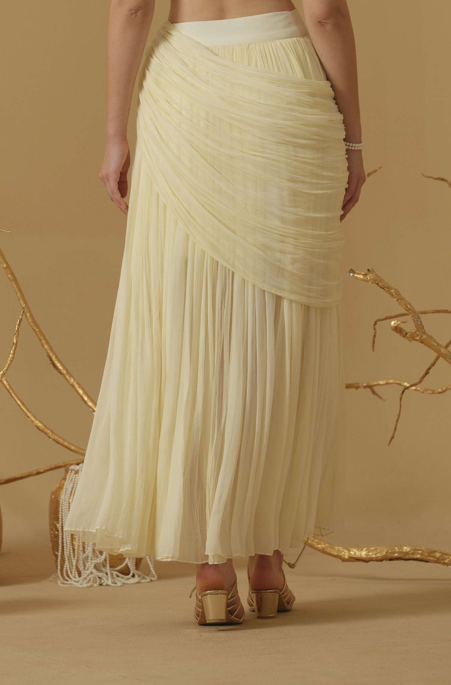 Draped Skirt With Slit Having A Brooch On The Side Of The Waist