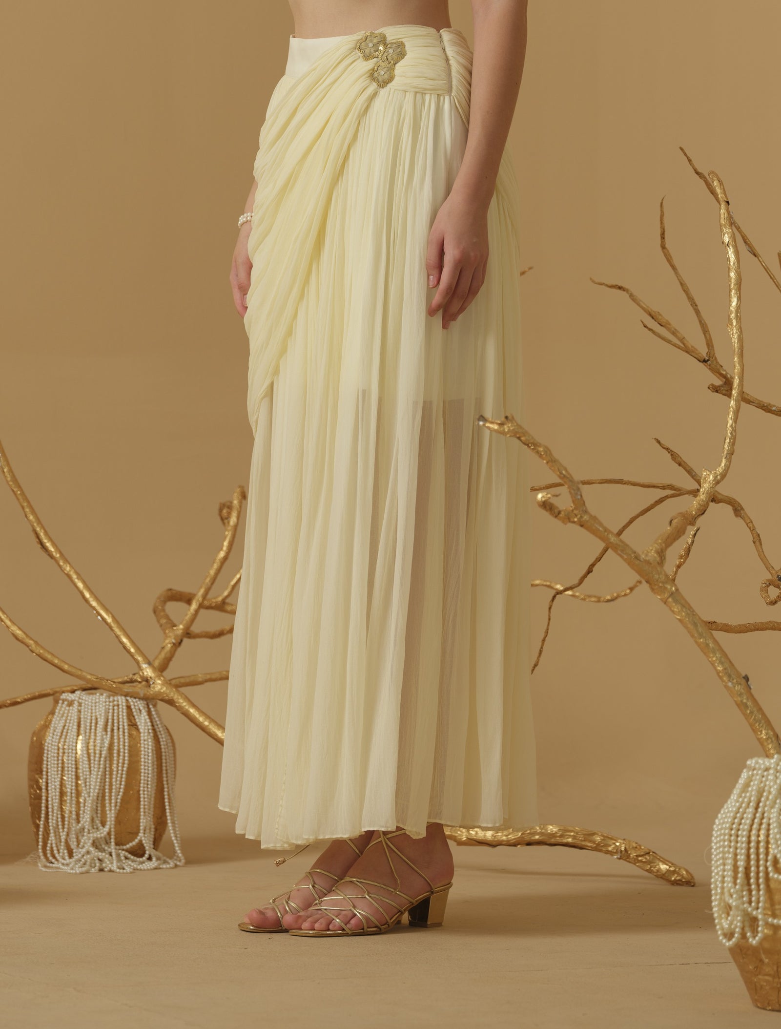 Draped Skirt With Slit Having A Brooch On The Side Of The Waist