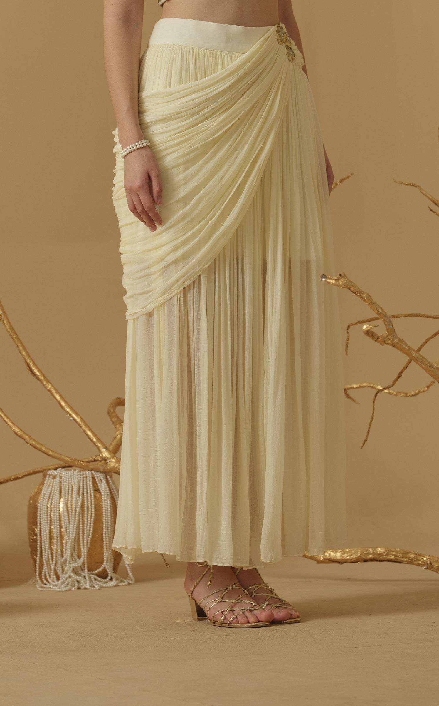 Draped Skirt With Slit Having A Brooch On The Side Of The Waist