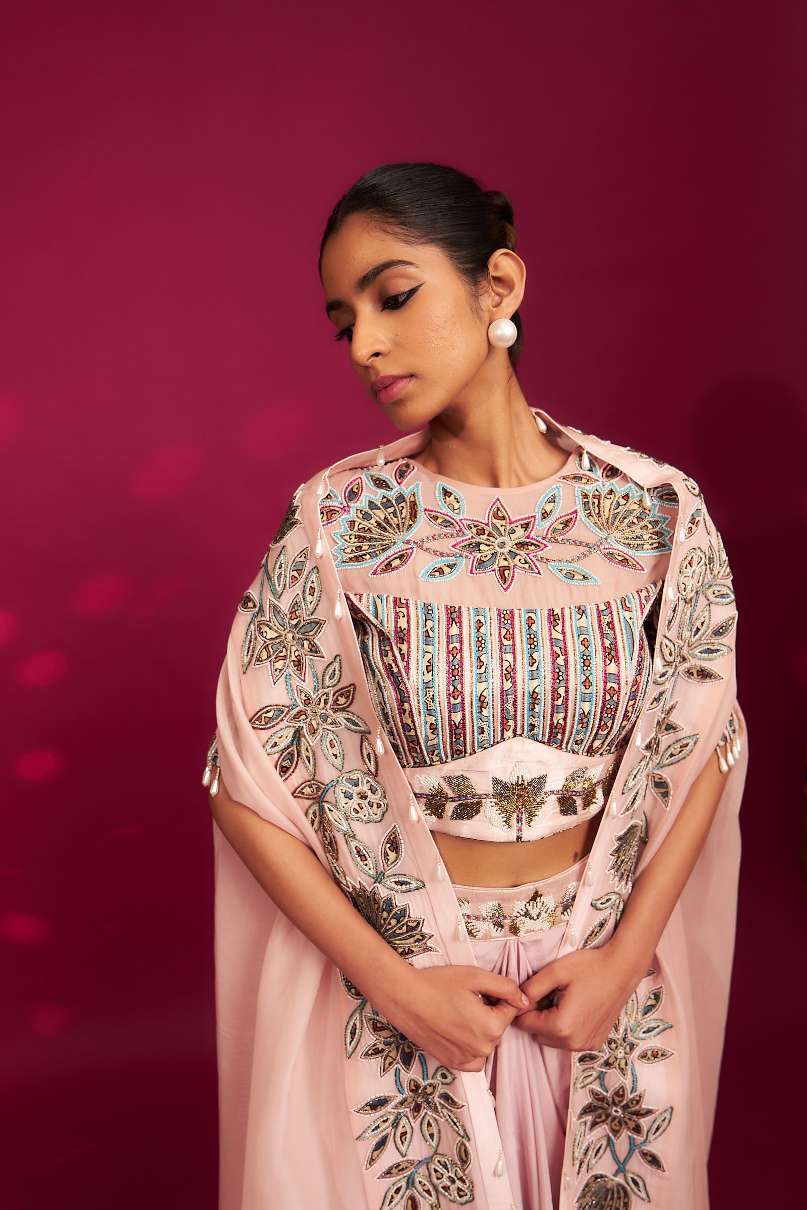 Peachy pink embellished ajrakh blouse with embroidered cape and dhoti