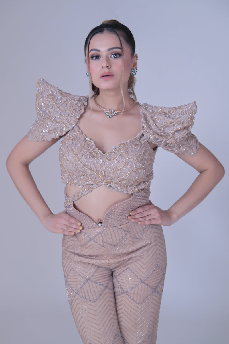 A beigh crop top with power shoulders