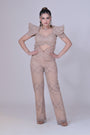 A beigh crop top with power shoulders
