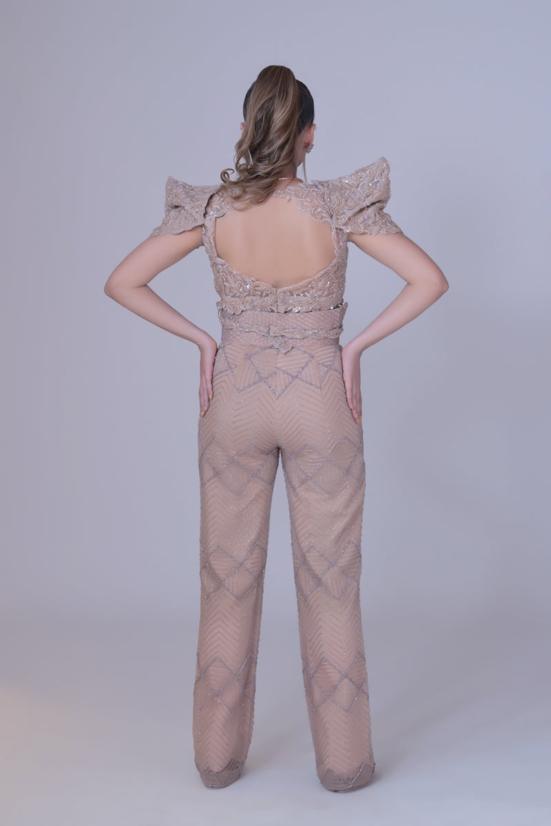 A beigh crop top with power shoulders