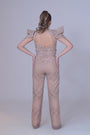 A beigh crop top with power shoulders