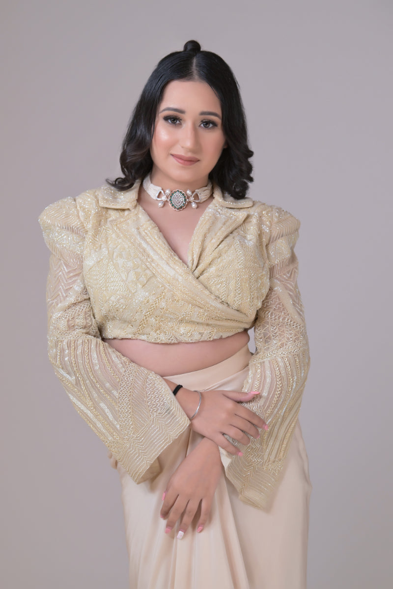 Ivory crop jacket with geometrical cutdana work and a crepe drape skirt