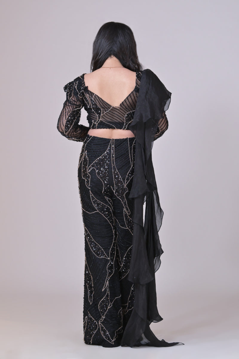 Black crop top with attached organza drape and embelished pants