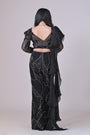 Black crop top with attached organza drape and embelished pants