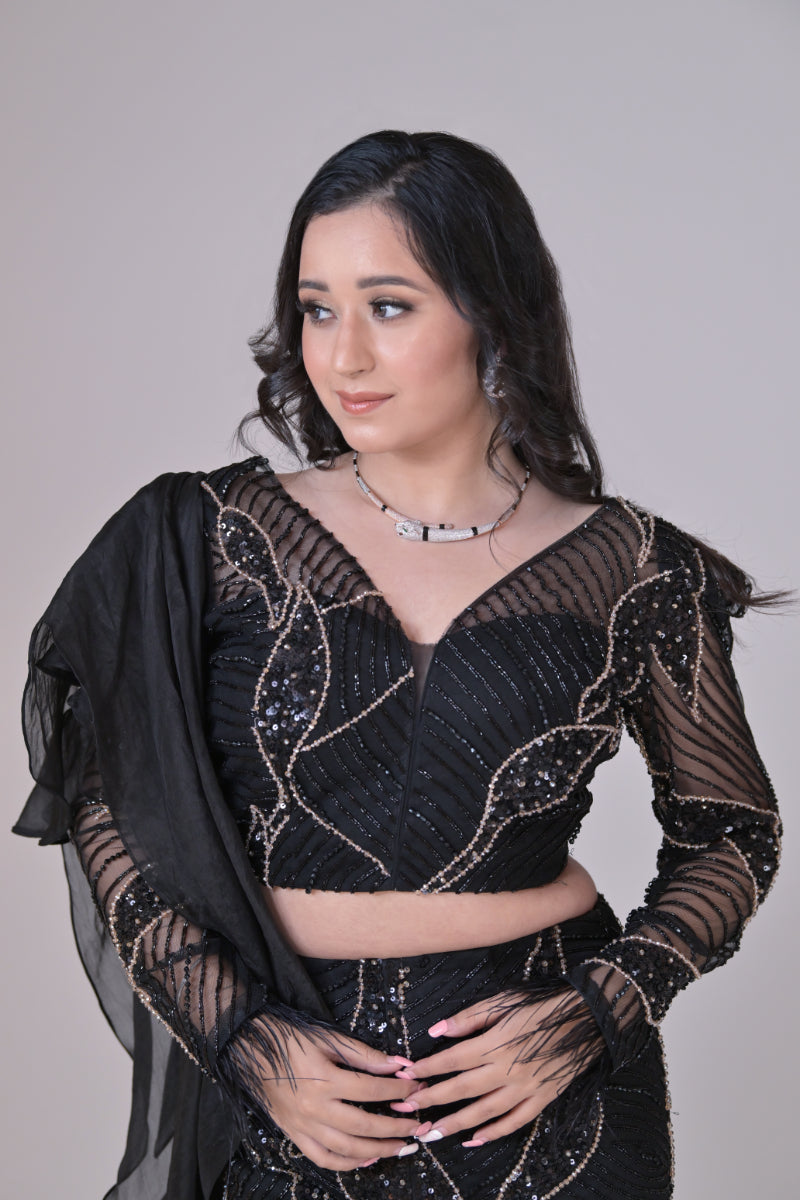 Black crop top with attached organza drape and embelished pants
