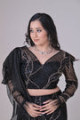 Black crop top with attached organza drape and embelished pants
