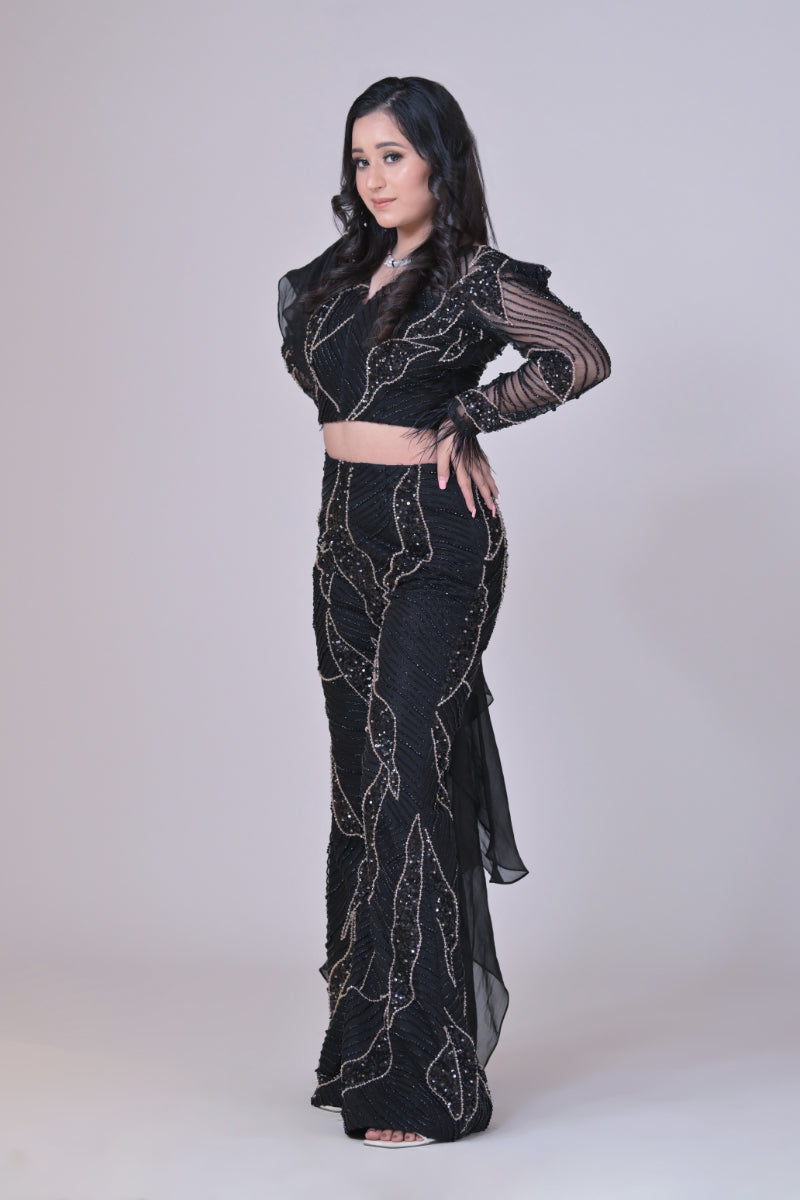 Black crop top with attached organza drape and embelished pants