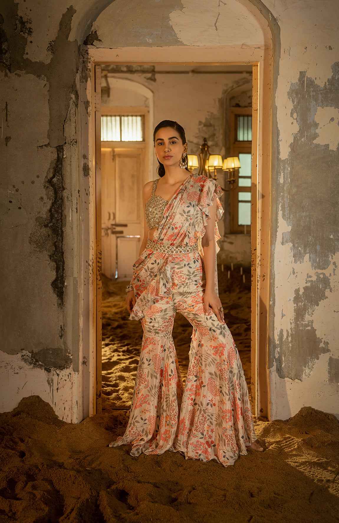 A Pre-Draped Sharara Saree Paired With Hand Embellished Bustier And Belt