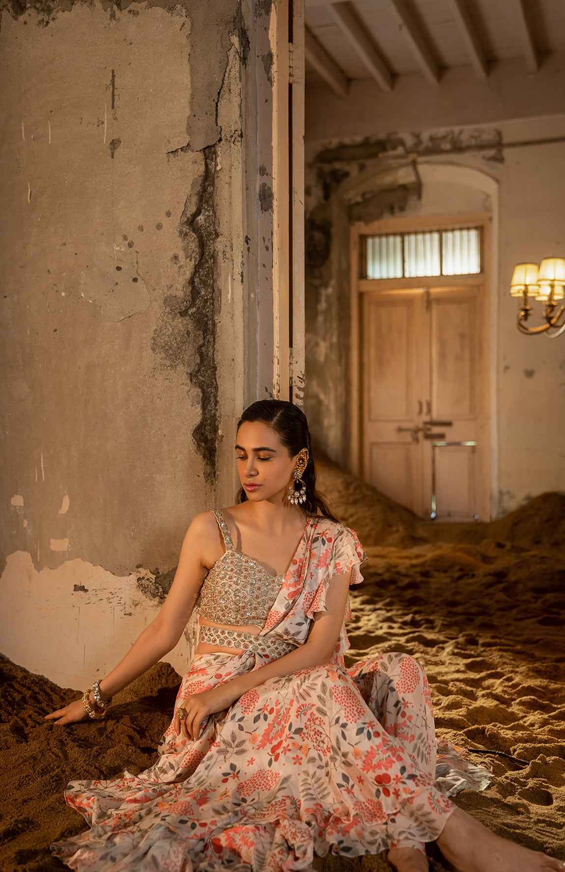 A Pre-Draped Sharara Saree Paired With Hand Embellished Bustier And Belt
