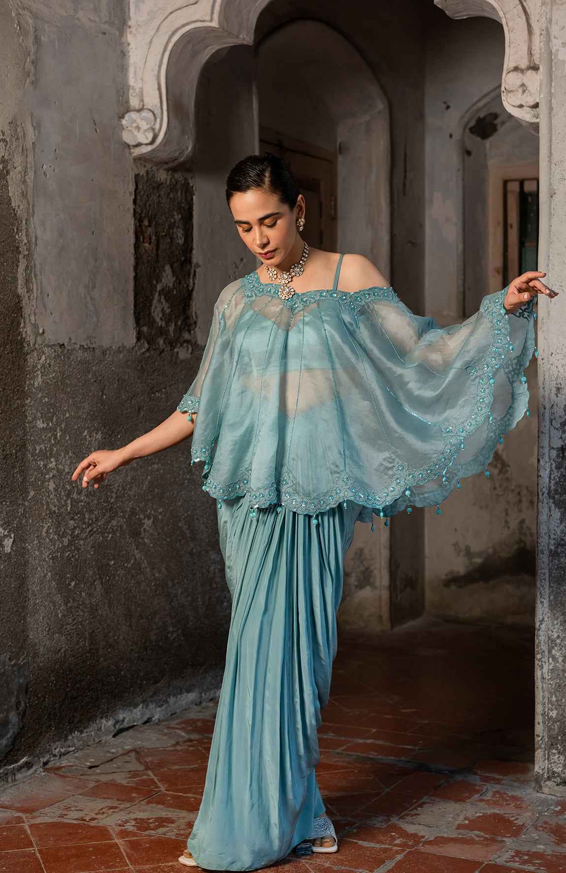 A Cape Set With Bustier And Draped Skirt