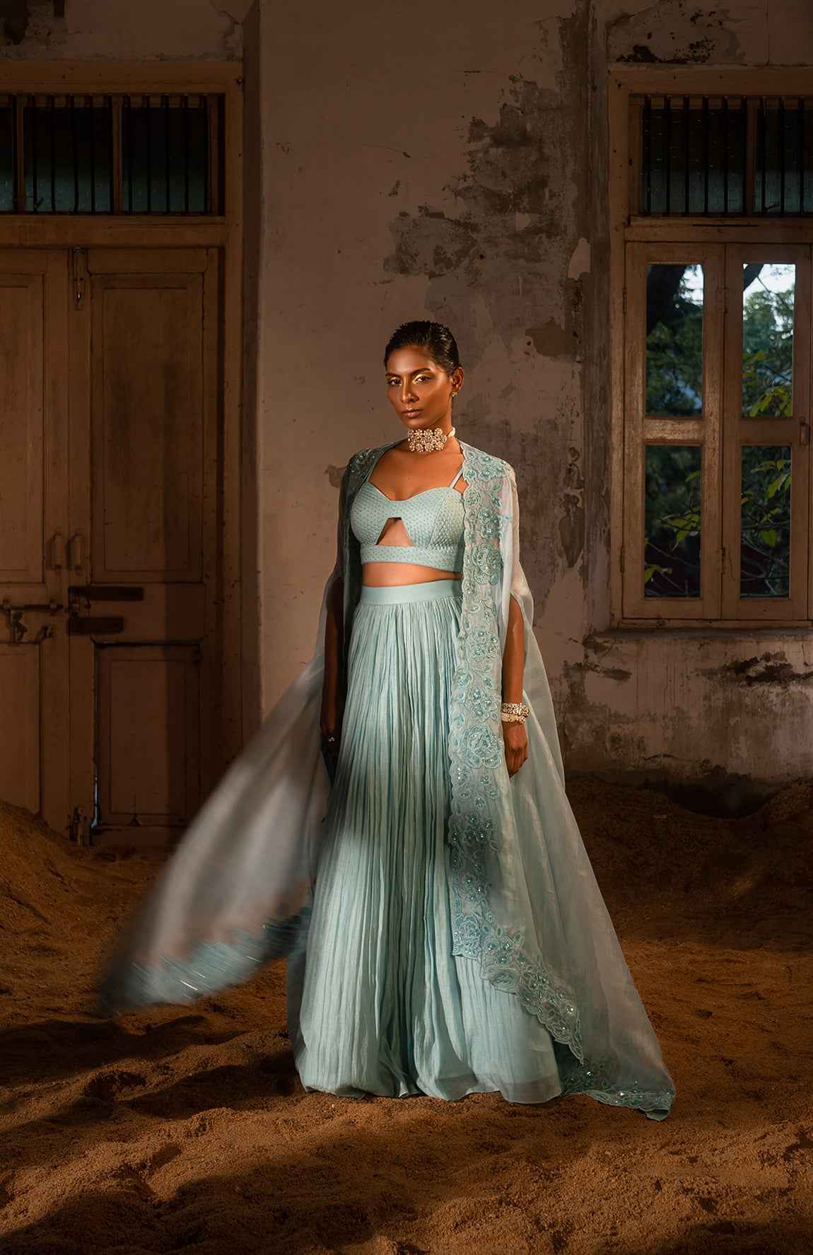 A Pwder Blue Lehenga With Maching Blouse And Cape