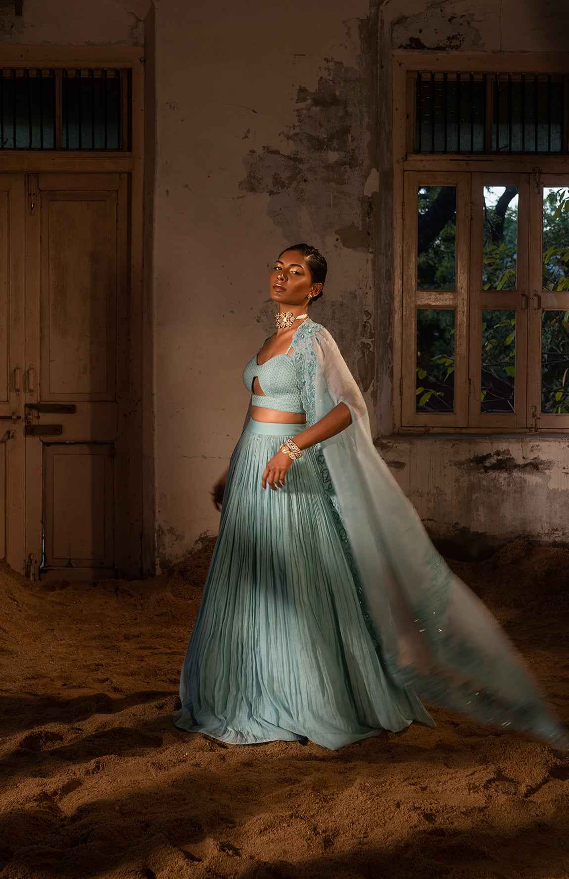 A Pwder Blue Lehenga With Maching Blouse And Cape