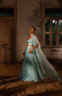 A Pwder Blue Lehenga With Maching Blouse And Cape