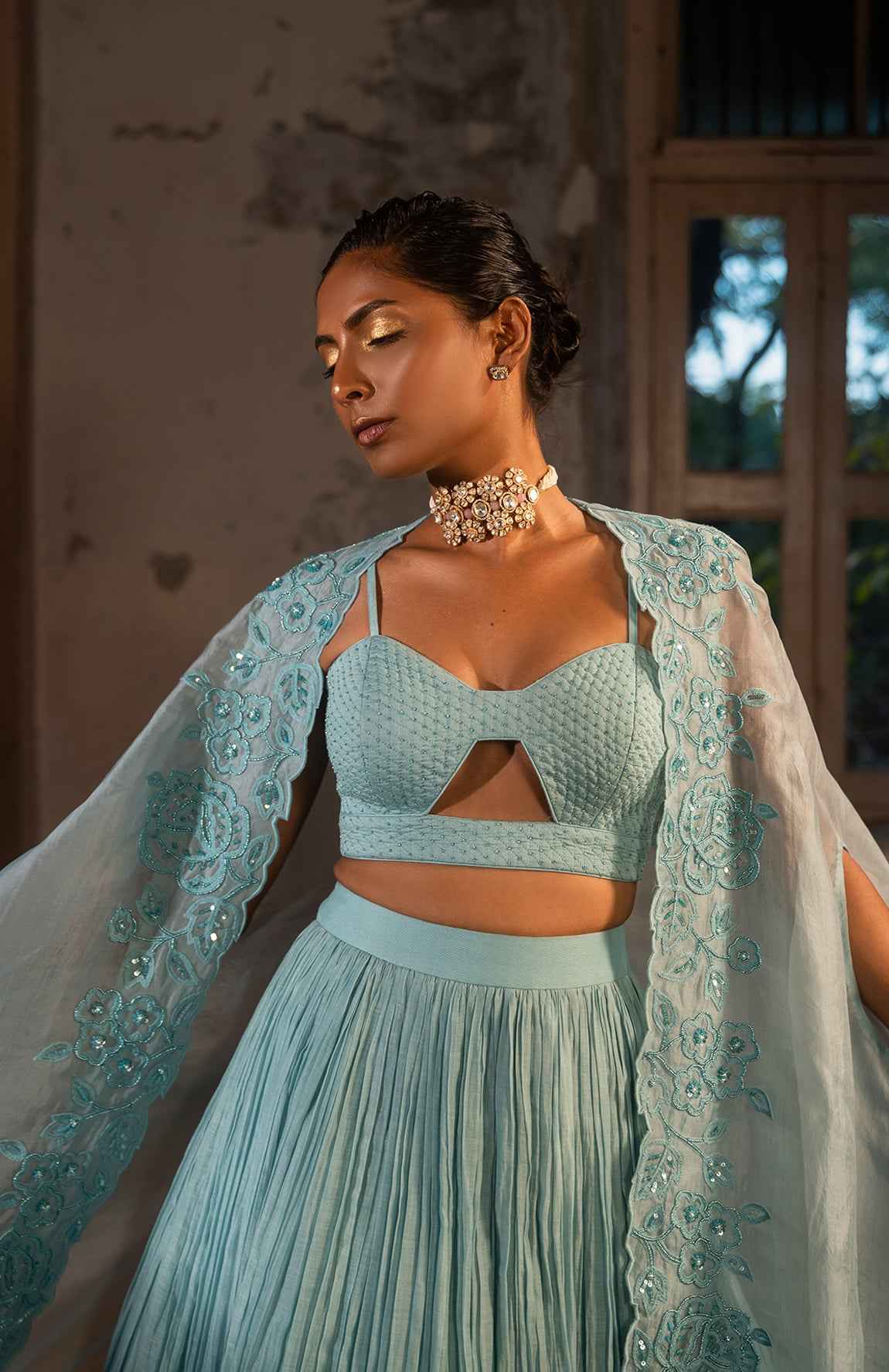 A Pwder Blue Lehenga With Maching Blouse And Cape