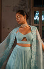 A Pwder Blue Lehenga With Maching Blouse And Cape
